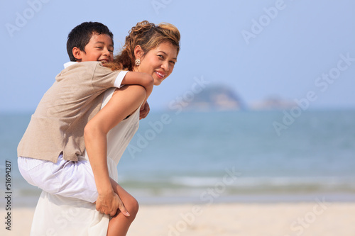 Mom and son play on beach
