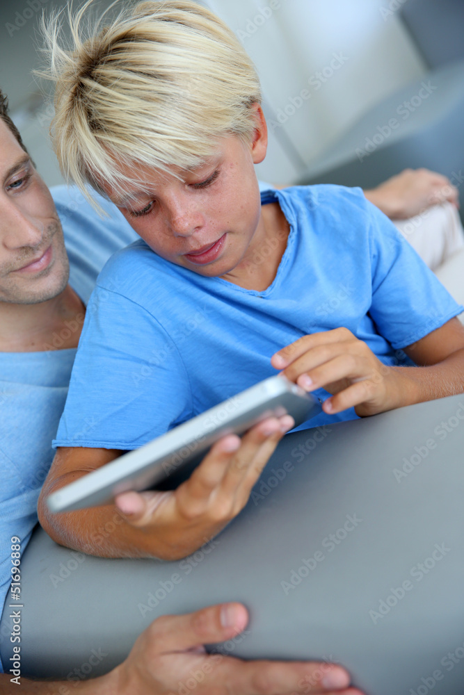 Father and son using digital tablet at home Father and son using digital tablet at home