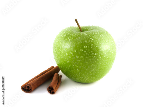 Isolated wet green apple with cinnamon pods