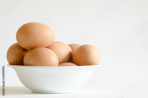 a pile of eggs on old white bowl