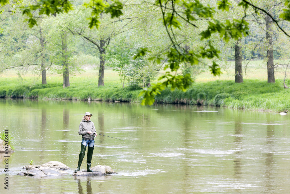 woman fishing in Sazava river, Czech Republic