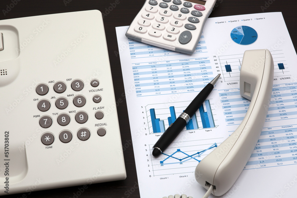 business report with telephone on a table business report with telephone on a table