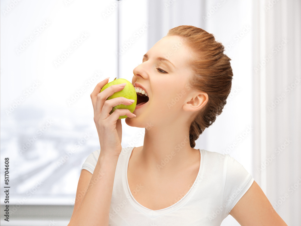 teenage girl biting a green apple teenage girl biting a green apple