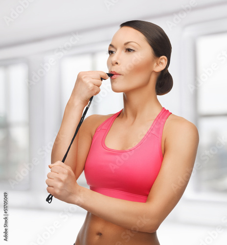 woman with whistle looking at something