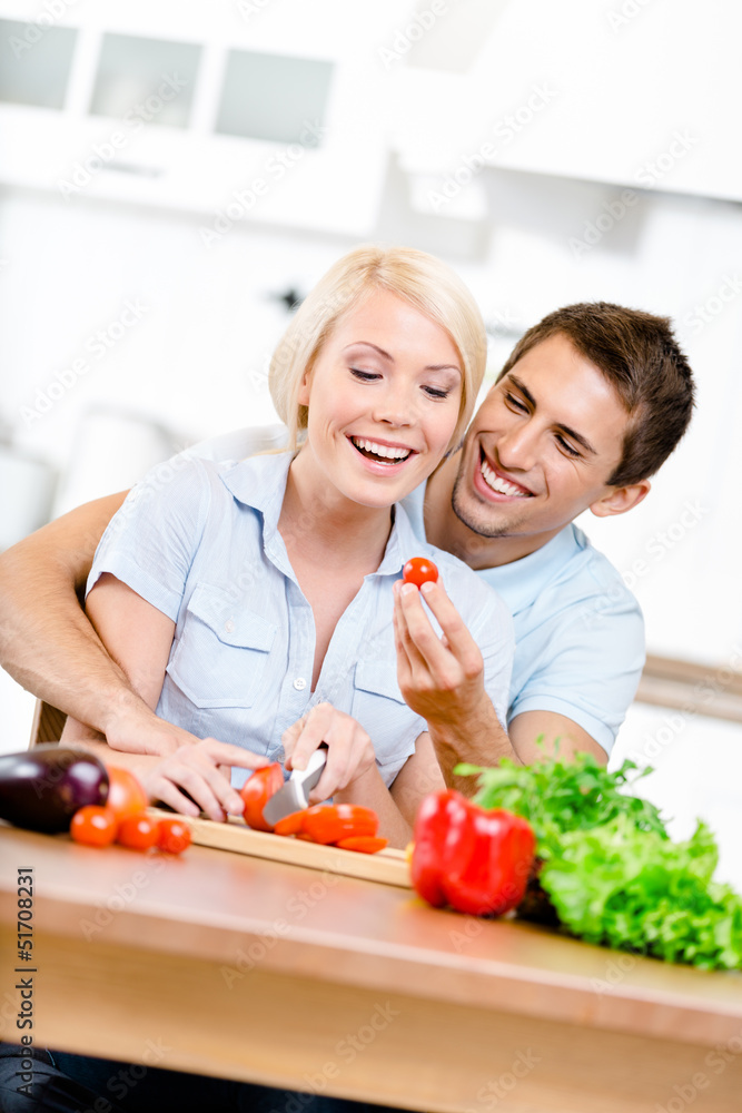 Couple cooking breakfast sitting together Couple cooking breakfast sitting together