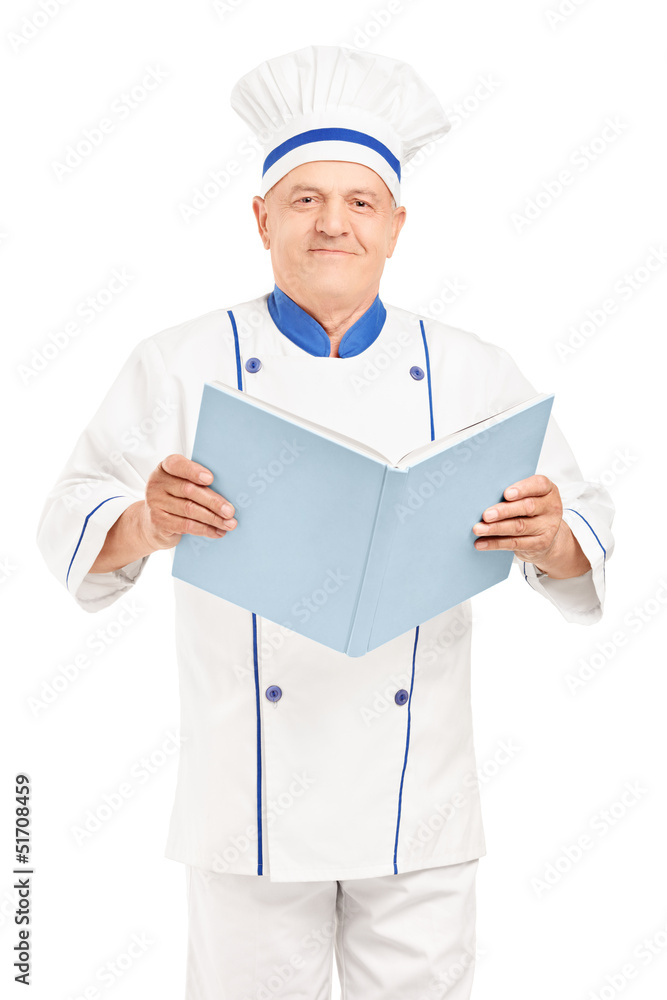 A mature chef holding a cookbook and looking at camera A mature chef holding a cookbook and looking at camera