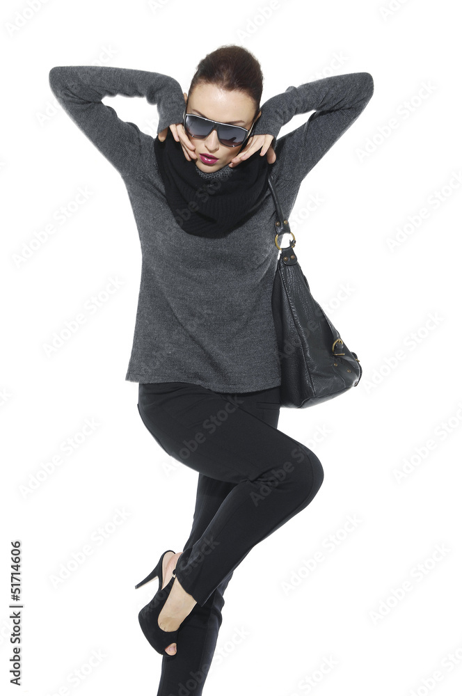 Full length of fashion girl with bag posing in the studio Full length of fashion girl with bag posing in the studio