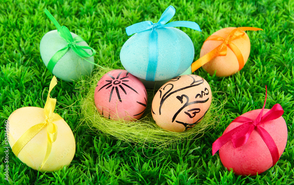 Fototapeta premium Colorful eastern eggs on grass background