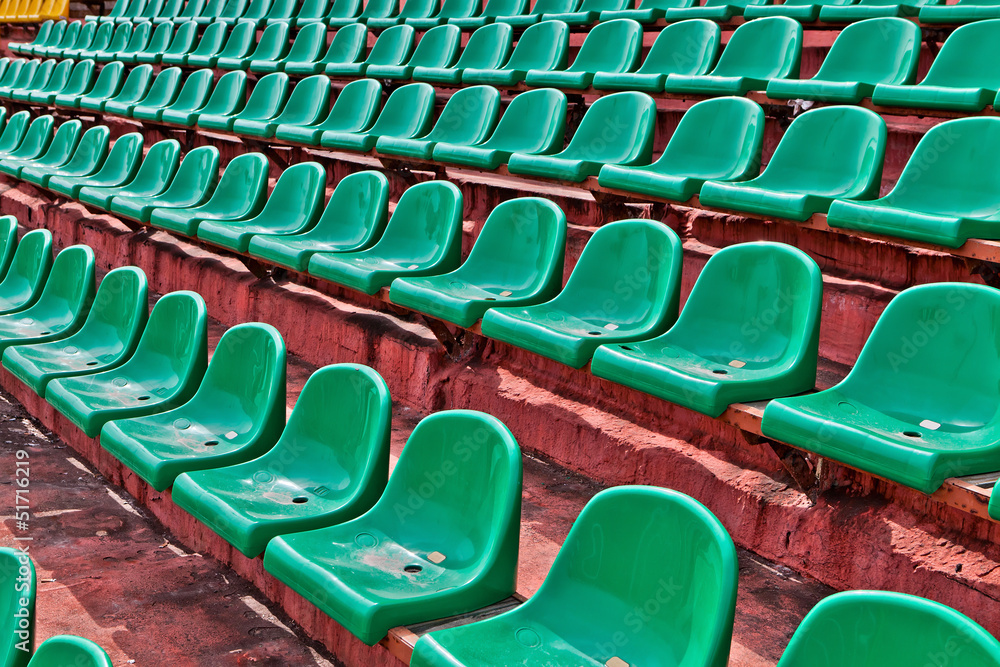 Fototapeta premium green plastic chairs on a football tribune