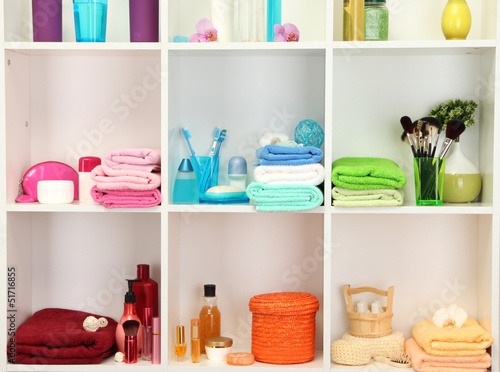 Bath accessories on shelfs in bathroom