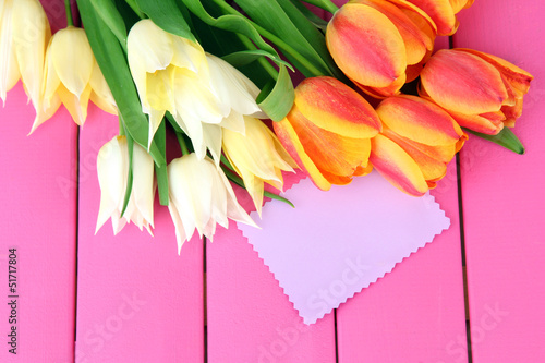 Fototapeta Naklejka Na Ścianę i Meble -  Beautiful white and orange tulips on color wooden background