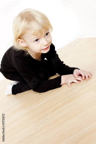 kneeling little girl wearing black clothes