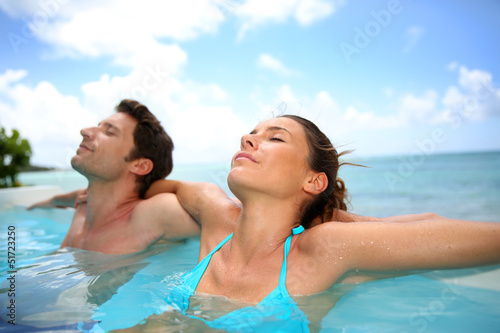 Couple relaxing in swimming pool © goodluz