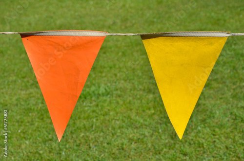 orange and yellow penants with grass background