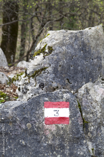 Red and white hiking trail signs symbol in European alps photo