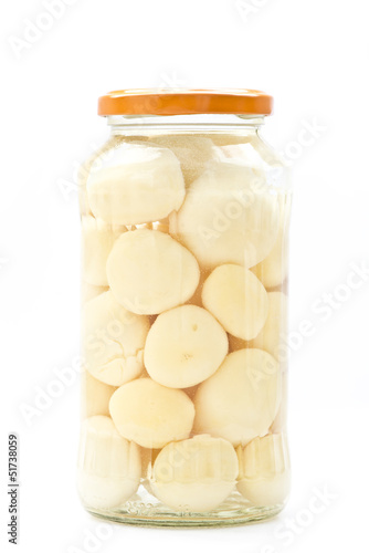 Potato in glass jar on a white background