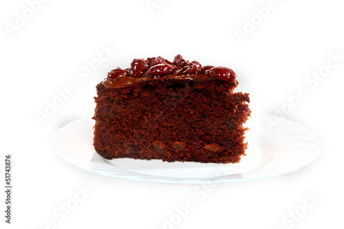 Piece of chocolate cake with icing and cherry