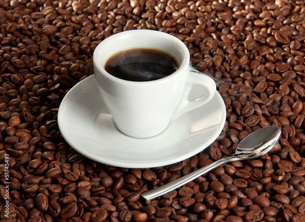 Cup of coffee on coffee beans background Cup of coffee on coffee beans background