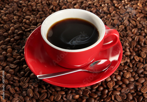 Cup of coffee on coffee beans background