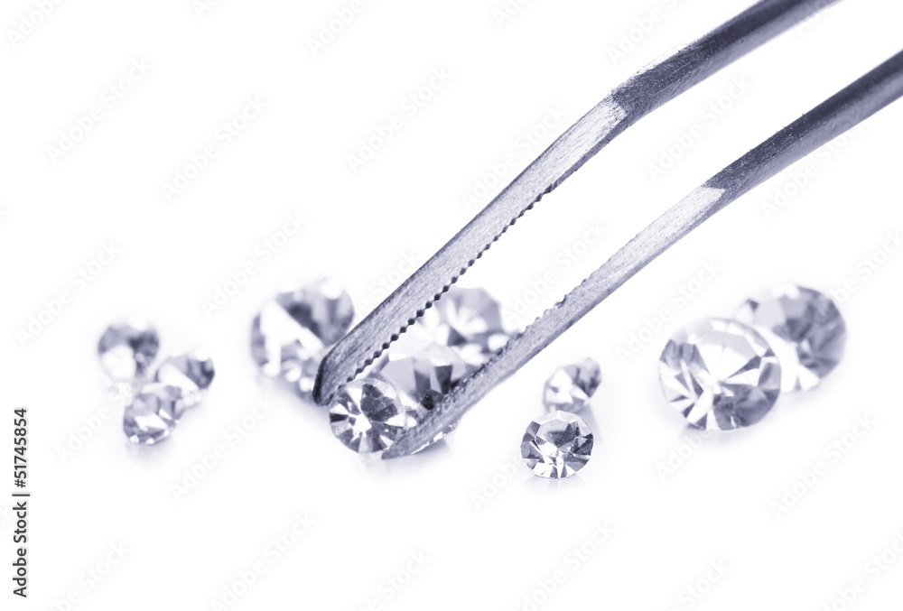 Beautiful shining crystal (diamond) in the tweezers, isolated Beautiful shining crystal (diamond) in the tweezers, isolated