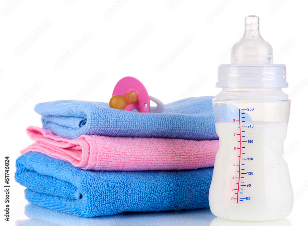 Bottle for milk with towels and nipple isolated on white Bottle for milk with towels and nipple isolated on white