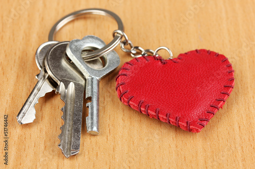 Fényképezés Key with leather trinket on wooden background