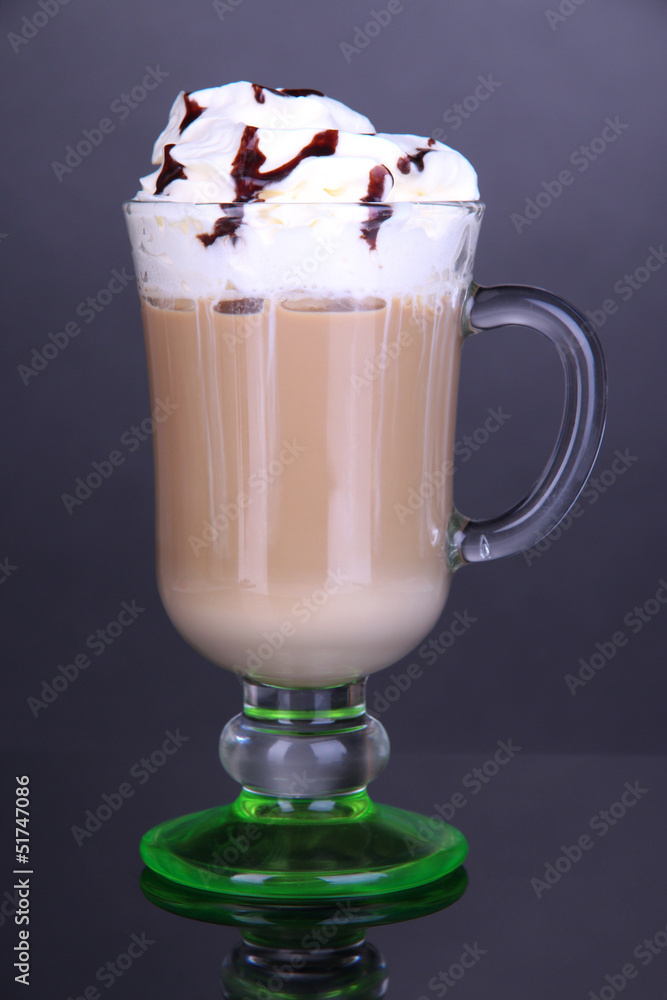 Layered coffee in glass on table on grey background Layered coffee in glass on table on grey background
