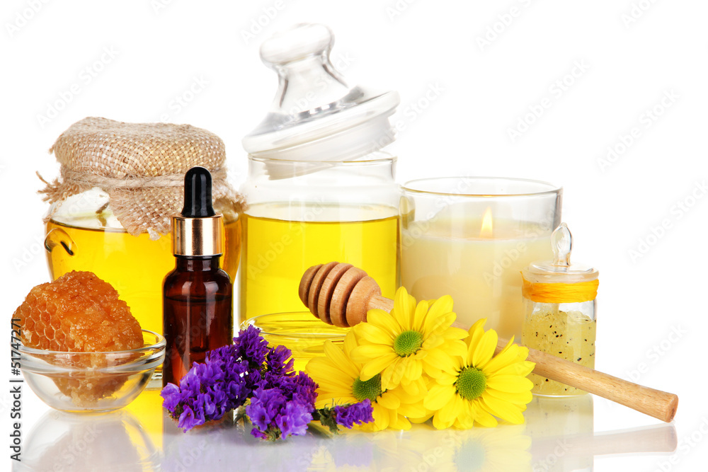 Fragrant honey spa with oils and honey isolated on white Fragrant honey spa with oils and honey isolated on white