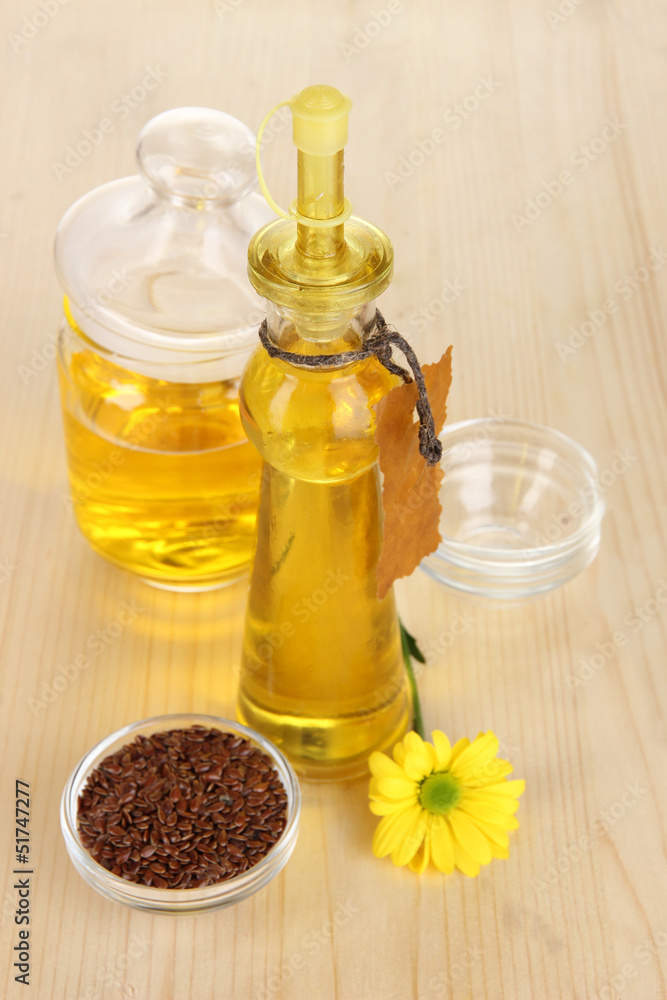 Useful linseed oil on wooden table close-up Useful linseed oil on wooden table close-up