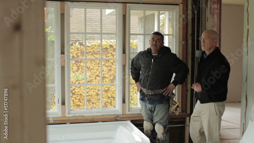 Architect and contractor looking at renovation plans