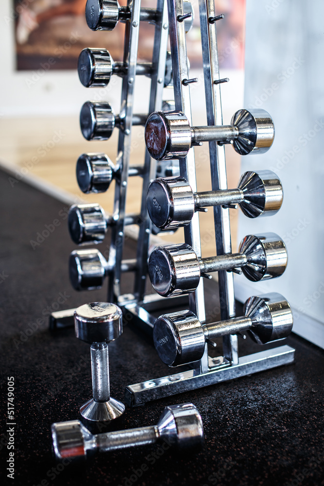 Naklejka premium A stand with different weight dumbbells