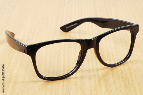 black glasses on wood background