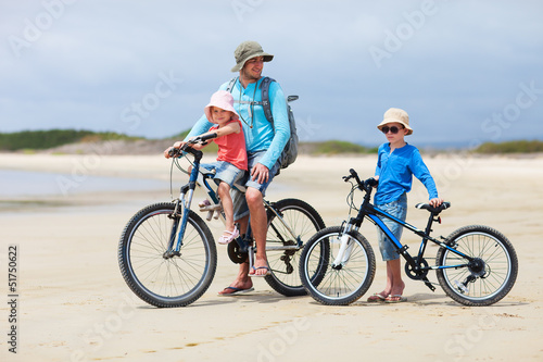 Father and kids riding bikes