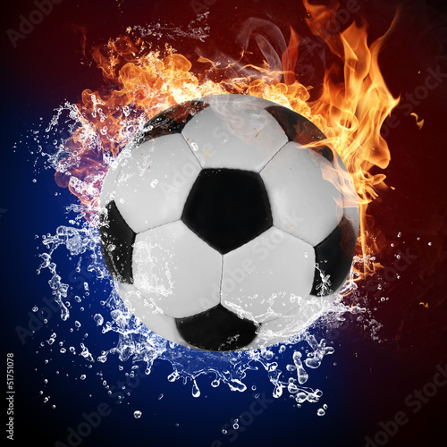 Soccer ball in fire flames and splashing water