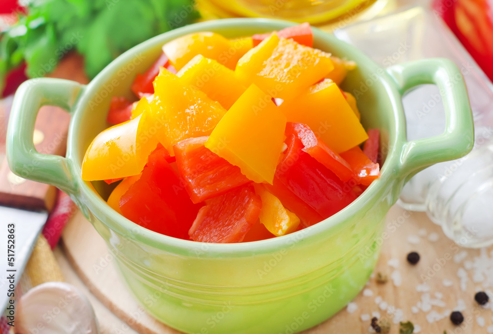 red and yellow peppers on wooden background red and yellow peppers on wooden background