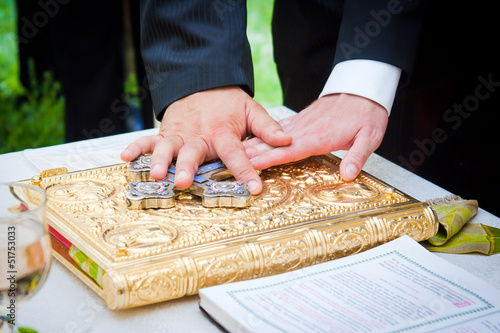 Hands on bible at a wedding ceremony