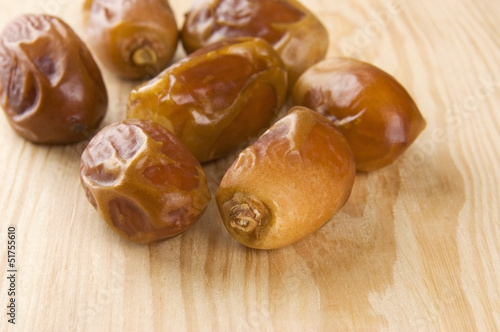 Dried dates on wooden background close up