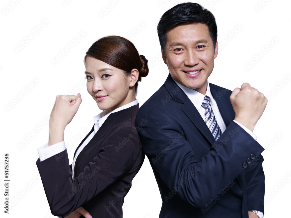 asian business people standing back-to-back, making a fist asian business people standing back-to-back, making a fist