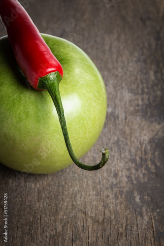 ripe green apple and chili pepper close up