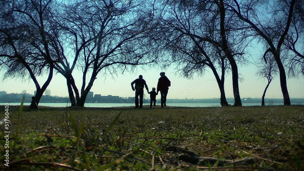 Happy couple with little boy running in the park Happy couple with little boy running in the park
