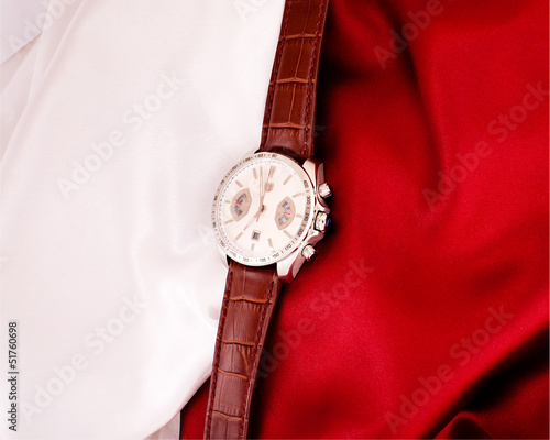 Men's mechanical watch on a background of red and white fabric