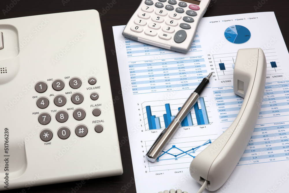 business report with telephone on a table business report with telephone on a table