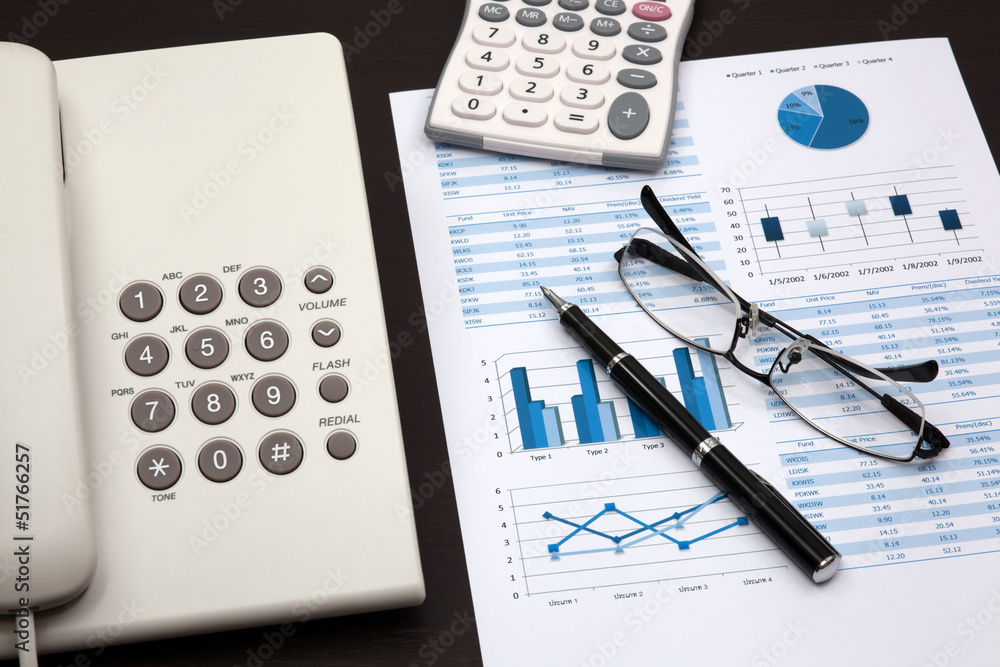 business report with telephone on a table business report with telephone on a table
