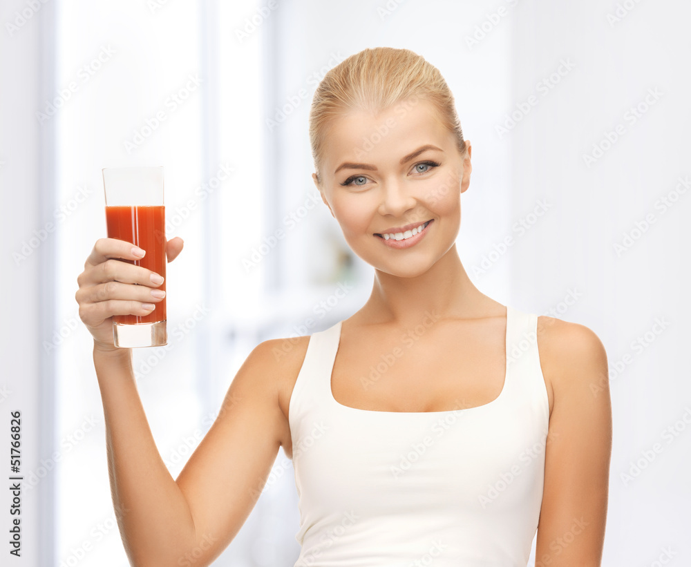 woman holding glass of tomato juice woman holding glass of tomato juice