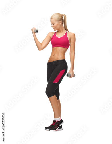 young sporty woman with light dumbbells