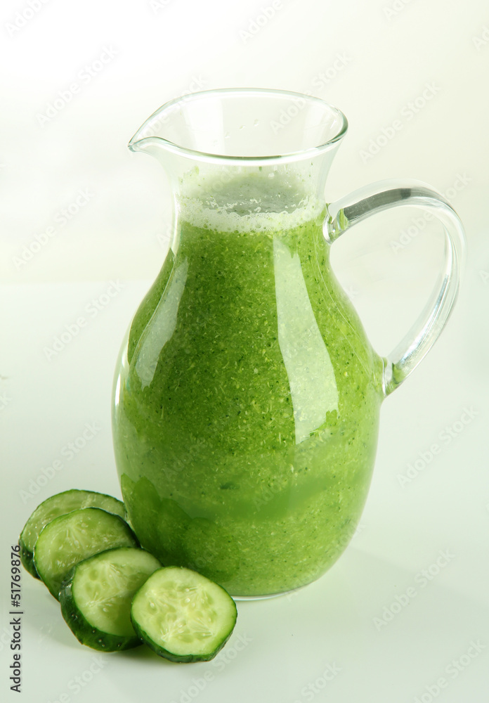 Glass pitcher of cucumber juice isolated on white Glass pitcher of cucumber juice isolated on white