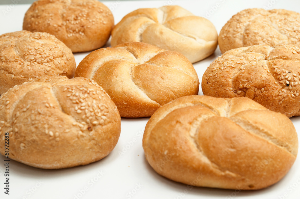 Close up of fresh rolls bread with sesame seeds from the oven