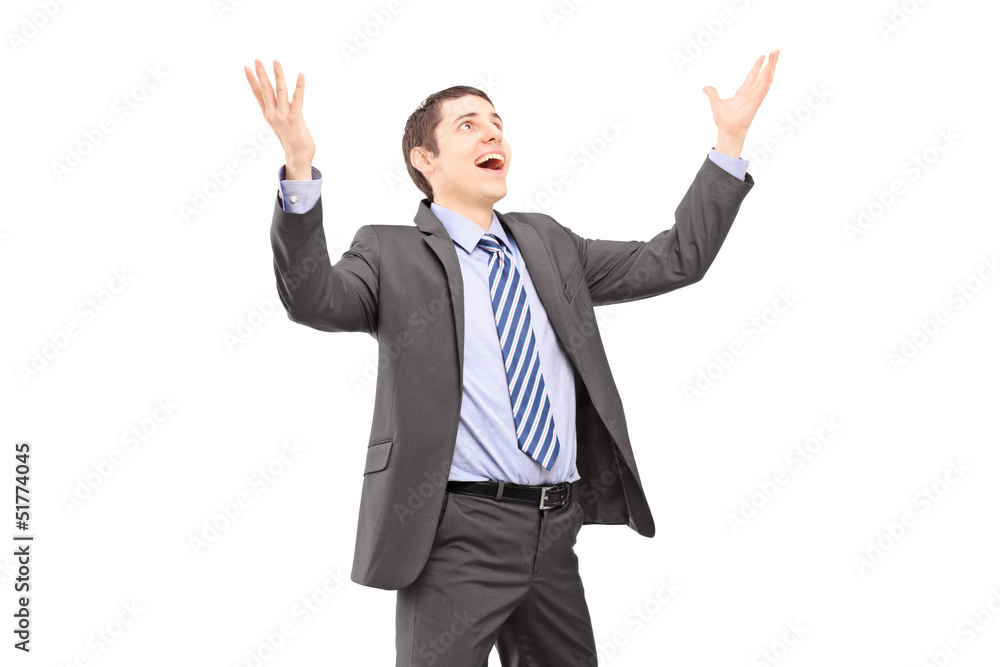 Young businessman with raised hands waiting something to fall Young businessman with raised hands waiting something to fall