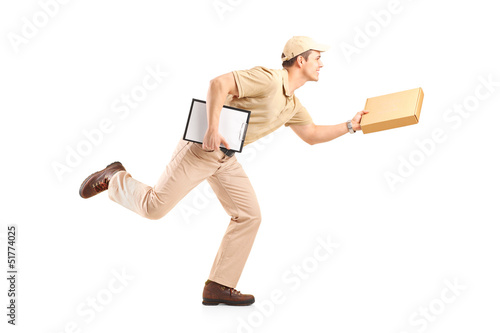 Full length portrait of a delivery boy in a rush delivering a pa photo