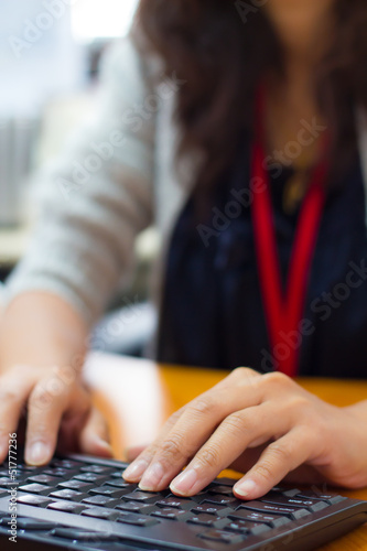 Female hands typing on a laptop